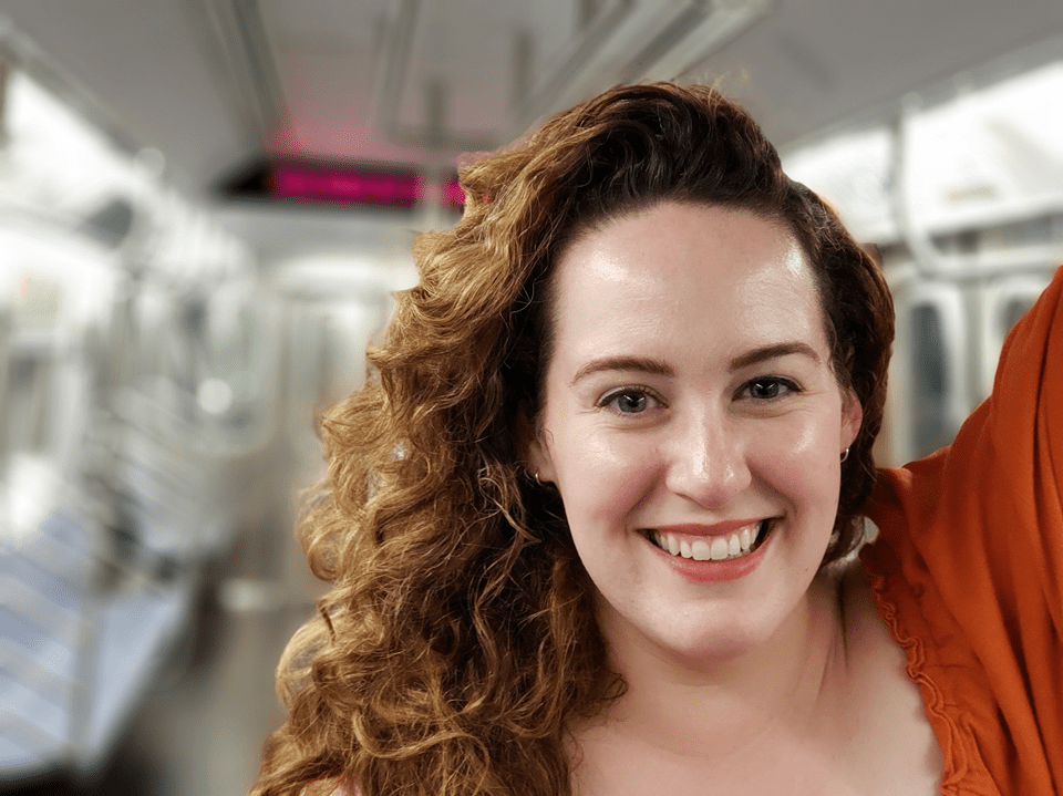 Photo of Emily Levin, looking fly, on an empty subway car.